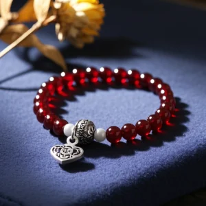 This bracelet is based on a classic retro style, designed for girls who like elegance and mystery. The bracelet is made up of 8 mm diameter deep red garnet beads, each garnet is like a gemstone treasured from an ancient castle, with a rich color like red wine and a deep luster. Dotted between the beads are a few small 925 sterling silver beads, the silver coldness contrasts with the garnet's enthusiasm, adding a touch of vintage charm. A small silver jewel with a rose pattern is designed at the clasp of the bracelet, symbolizing eternal love and beauty. The overall design is noble and elegant, and when worn, it seems that people can travel through time and space and feel the elegance and mystery of medieval aristocracy.